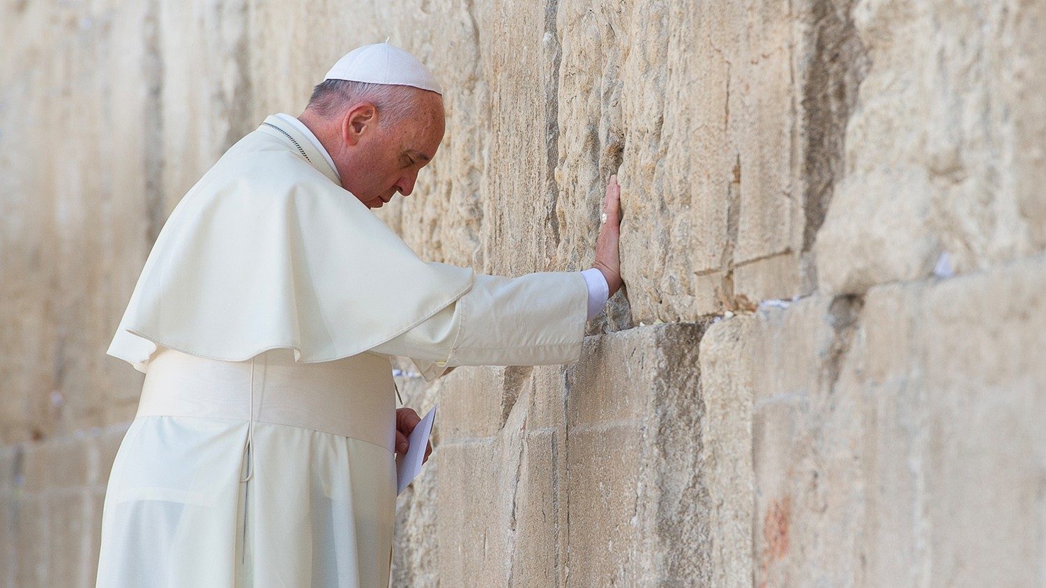Pope Francis placing a prayer in the Western Wall